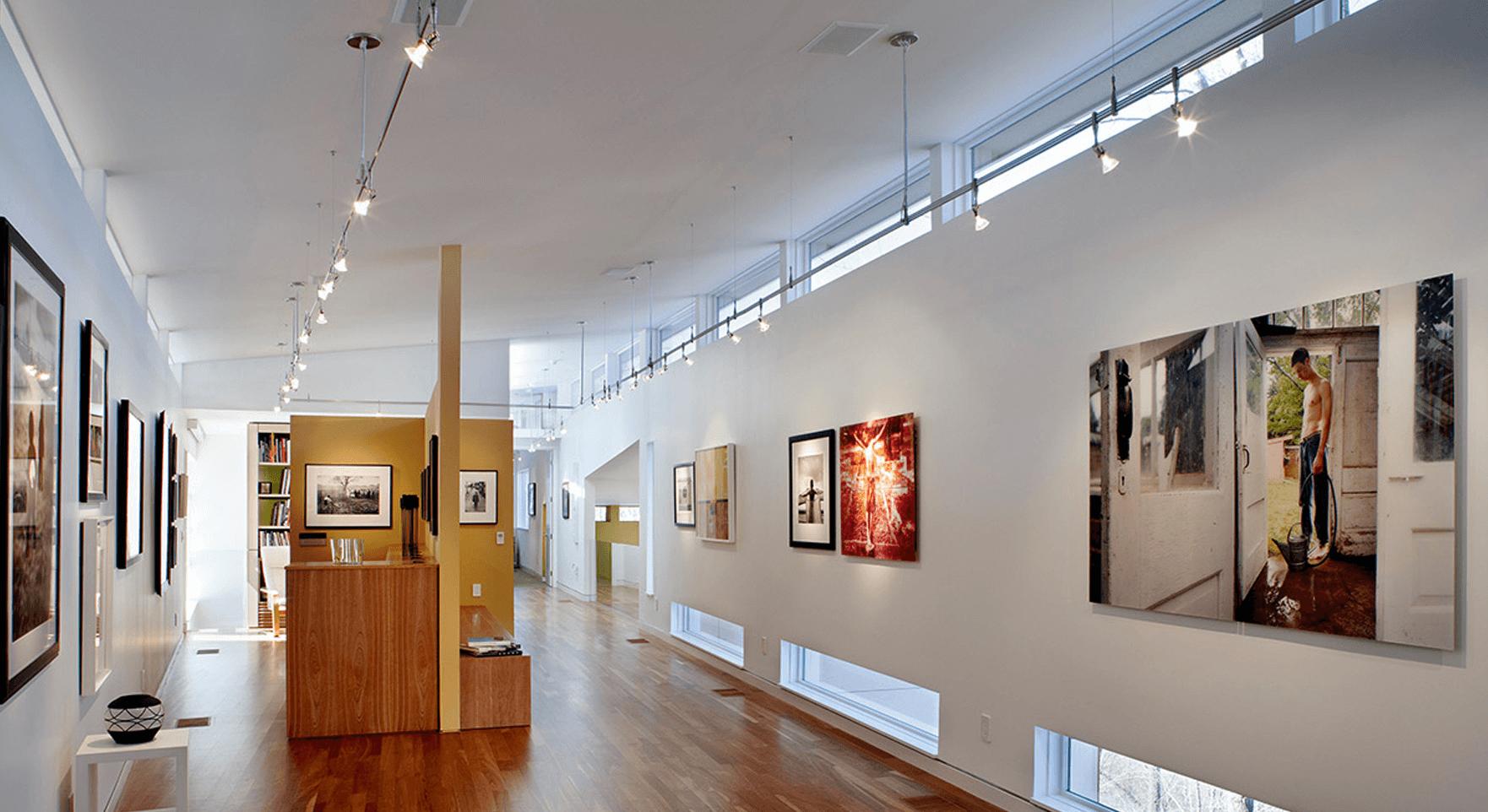 a hallway with frames in the wall