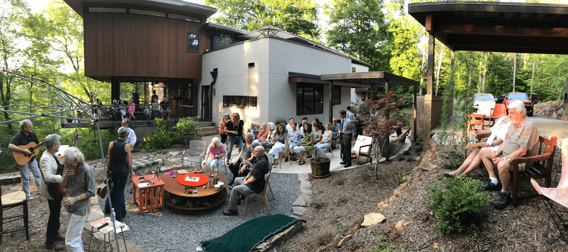 a group of people gathering around a house
