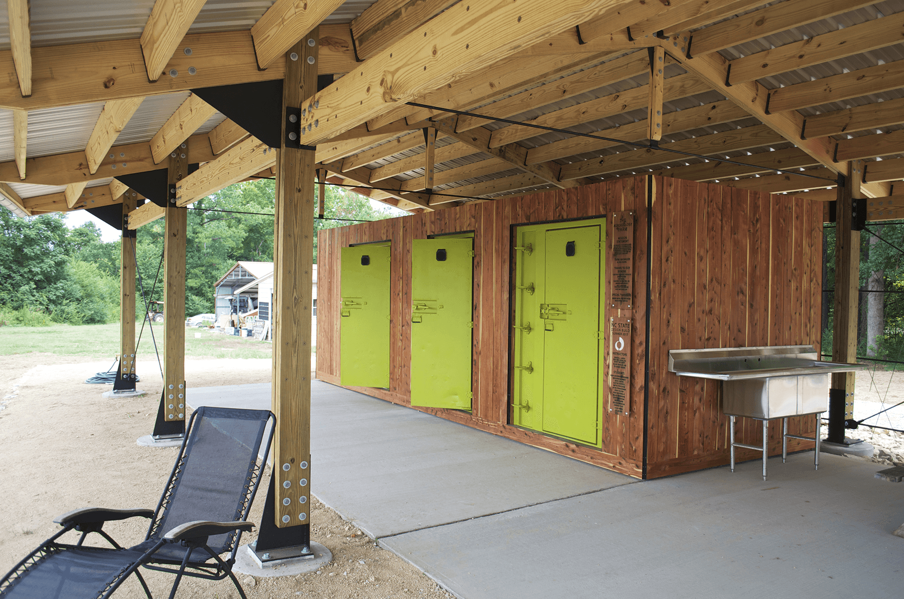 a row of portable toilets in a covered area