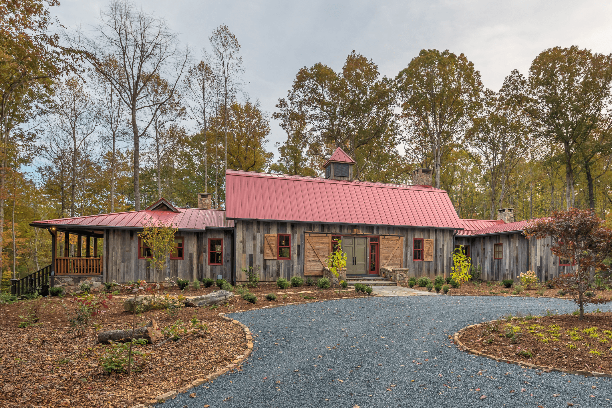 a house with a red roof surrounded by trees