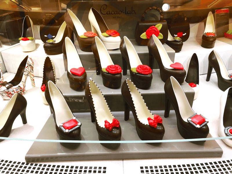 a display of chocolate shoes with roses on them